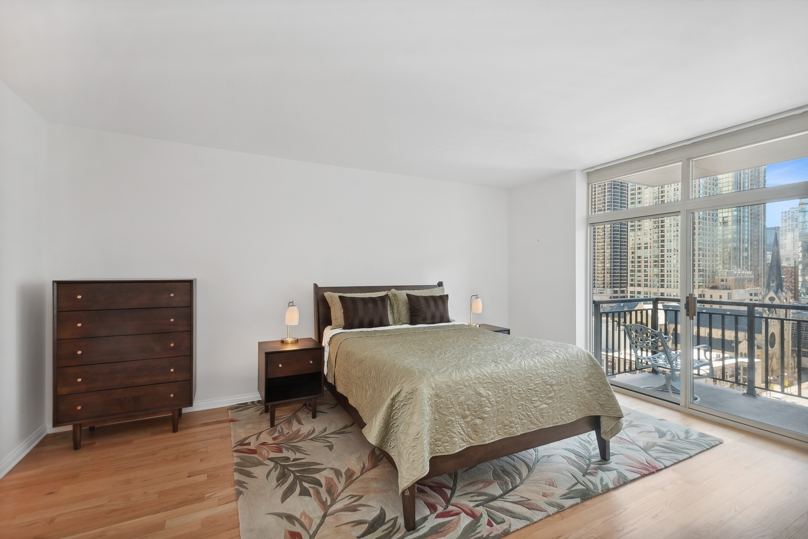 21 West Chestnut Street, Unit 1408 Chicago, IL 60610 - Photo 8 of 17 a bedroom with a bed and a dresser