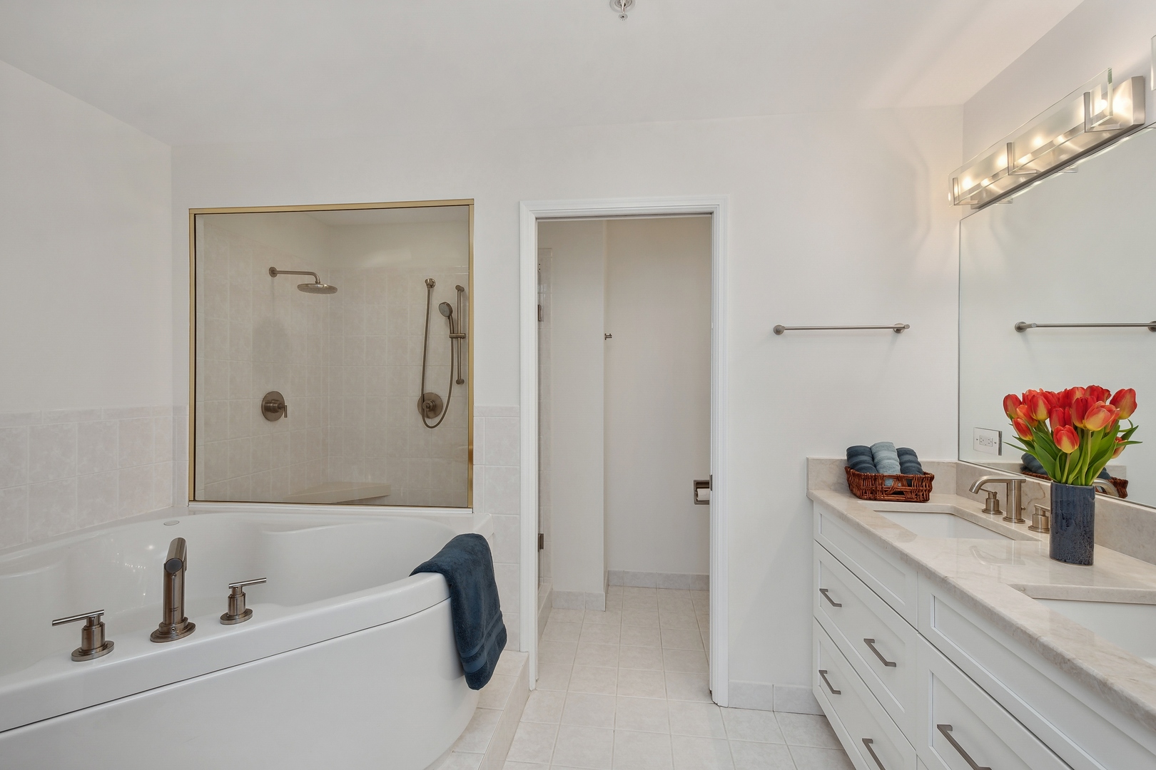 21 West Chestnut Street, Unit 1408 Chicago, IL 60610 - Photo 9 of 17 a bathroom with a tub sink and mirror