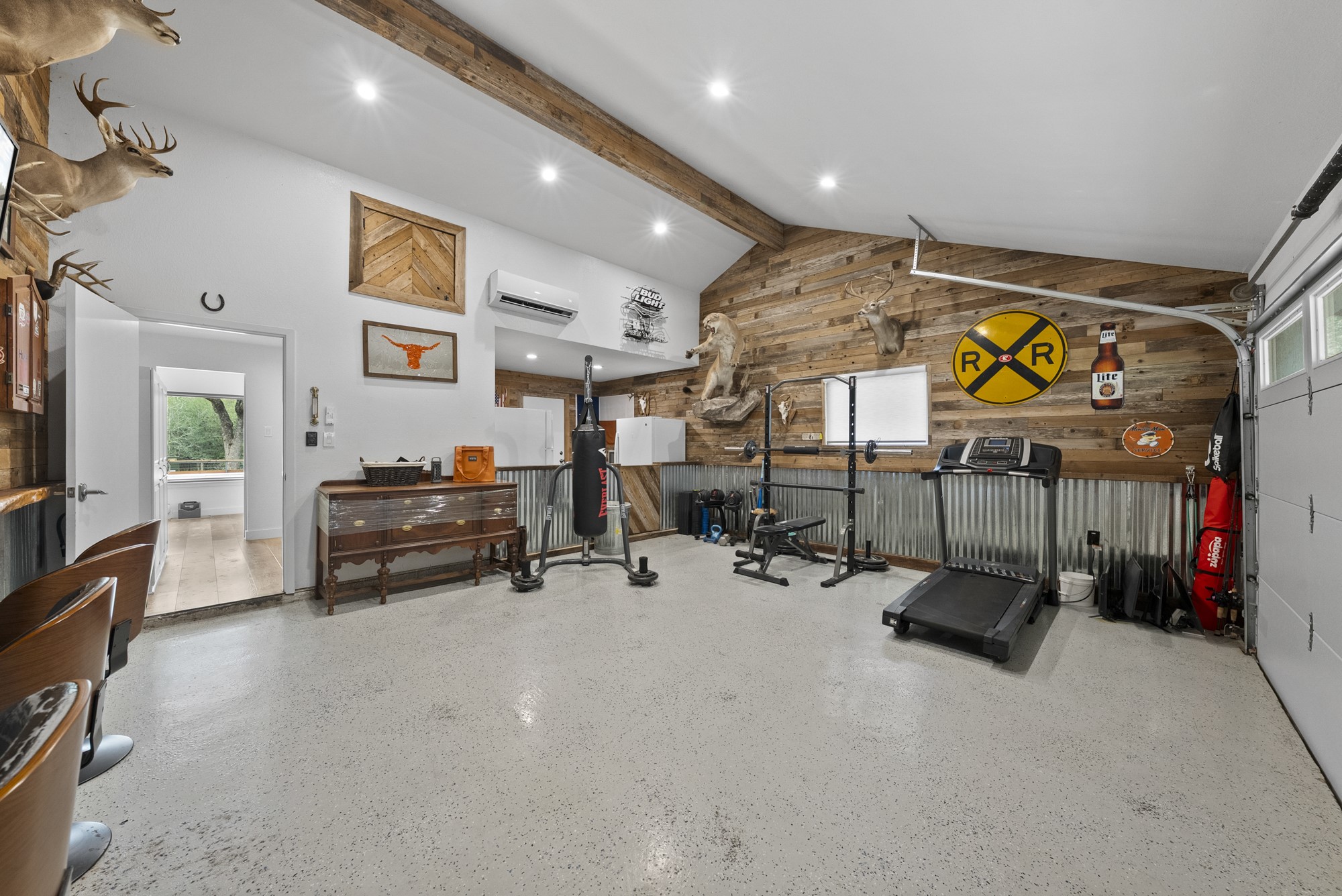 2802 Robin Road Manchaca, TX 78652 - Photo 14 of 40 Spacious room featuring vaulted ceilings with exposed wood beams, recessed lighting, and a textured wood-finish accent wall