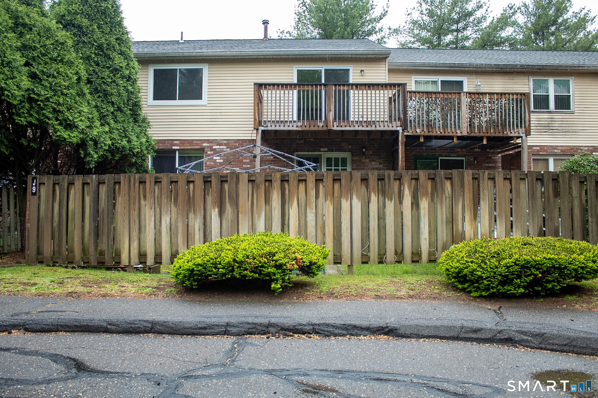 10 Georgetown Drive, Unit J Enfield, CT 06082 - Photo 14 of 15 a front view of a house with a yard and potted plants