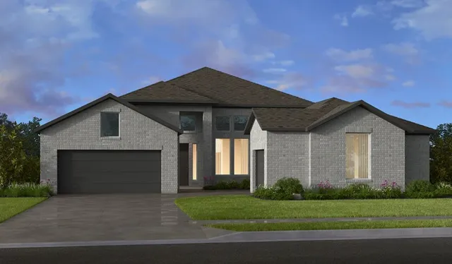 a front view of a house with a garden and garage