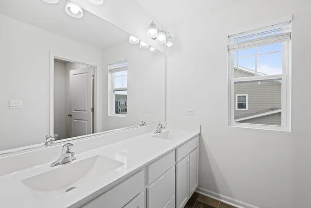 a bathroom with a sink vanity and a mirror