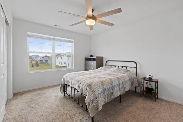 a bedroom with a bed and window