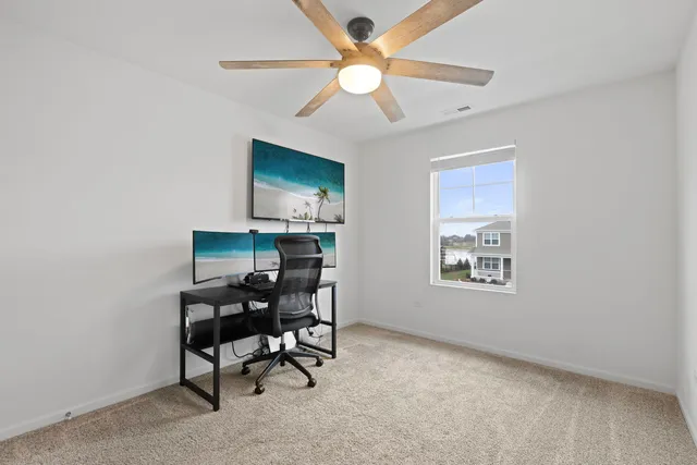 a workspace with furniture and chandelier fan