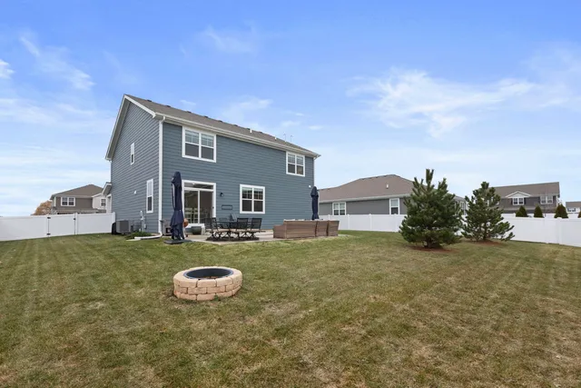 a view of a house with backyard and sitting area