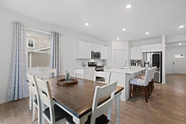 a view of a dining room with furniture and wooden floor