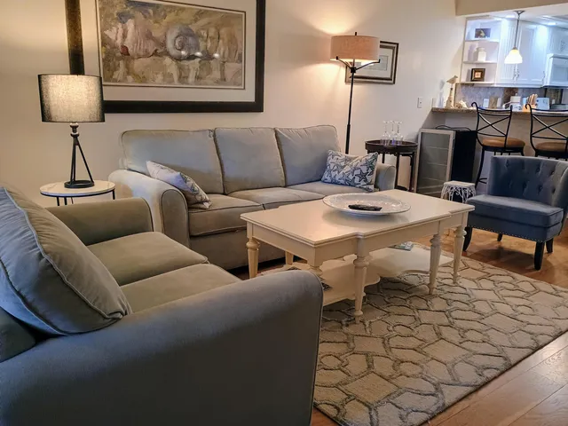 a living room with furniture and a lamp