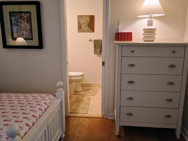 a kitchen with a wooden floor and cabinets