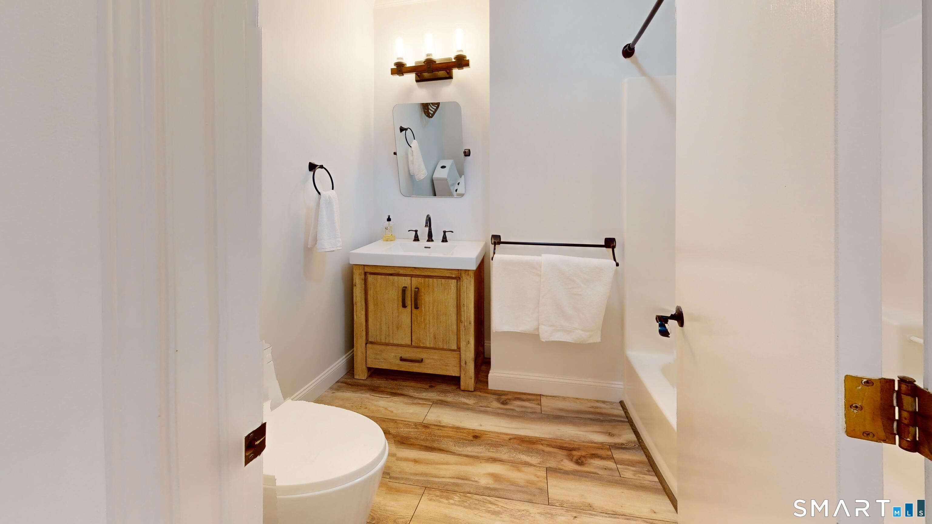 29 Deer Ridge Road Stonington, CT 06378 - Photo 12 of 35 a bathroom with a sink toilet and mirror