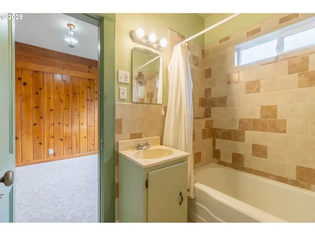 a bathroom with a sink a bathtub and a shower