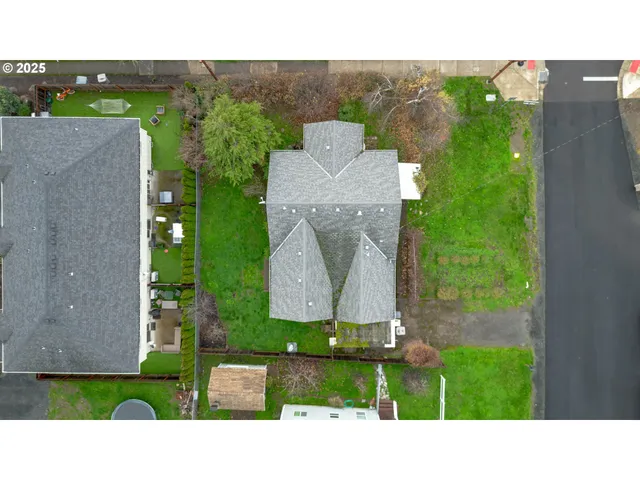 an aerial view of a house with a garden and a yard
