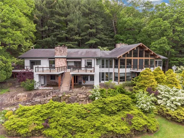 a front view of a house with a garden