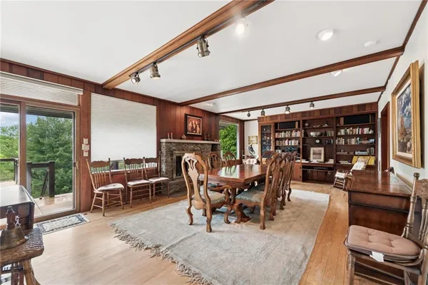 a dining room with furniture water view and a floor to ceiling window