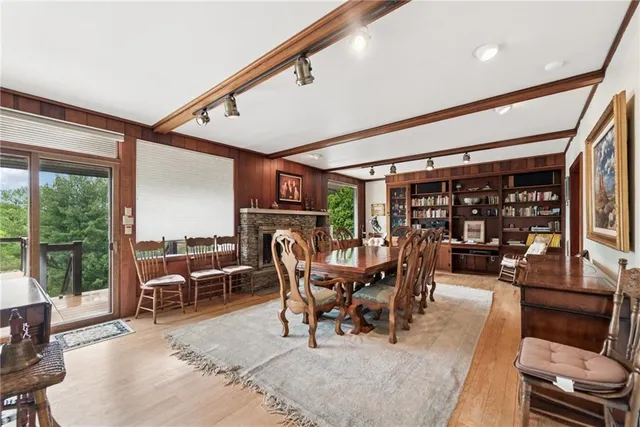 a dining room with furniture water view and a floor to ceiling window