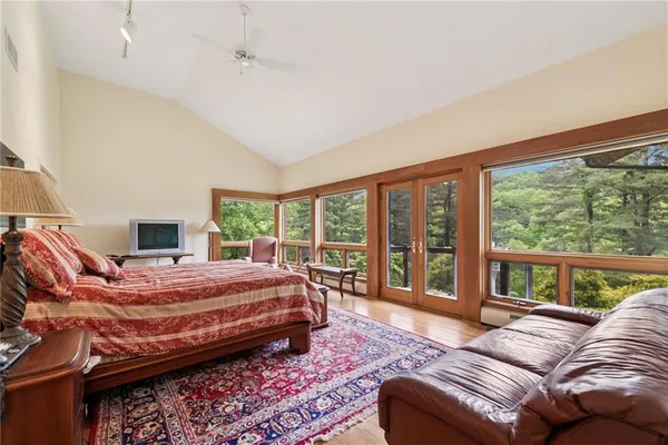 a bedroom with a large bed and a large window