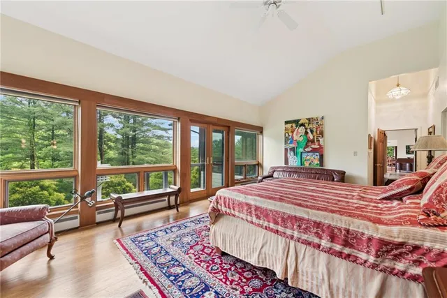 a bedroom with a large bed and a large window