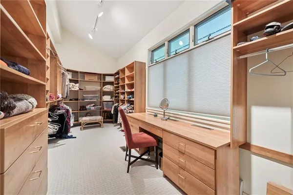 a view of a workspace with furniture and a window