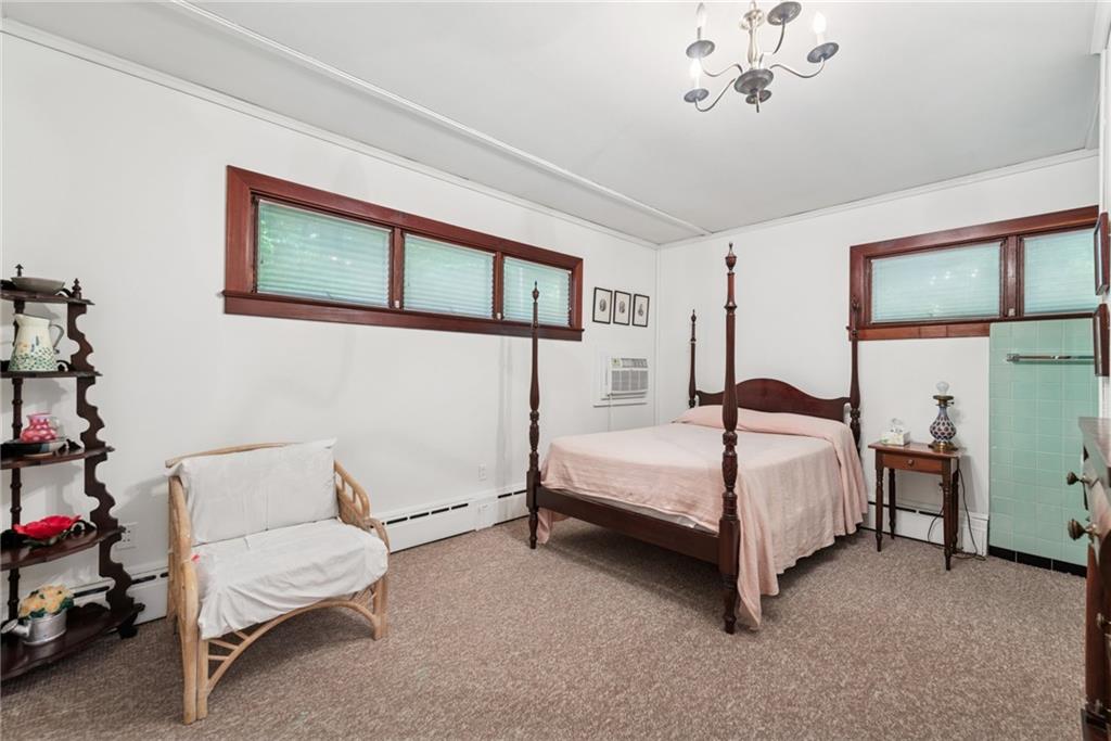 428 Jefferson School Road Ligonier, PA 15658 - Photo 25 of 50 a bedroom with a bed and a chandelier