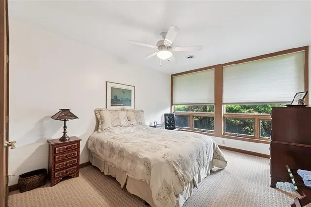 a bedroom with a large bed and a large window