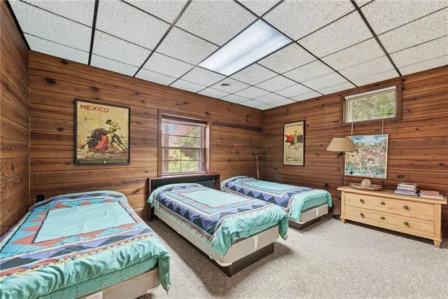 a bedroom with a bed dresser and window