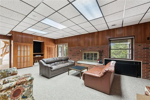 a living room with furniture and a fireplace
