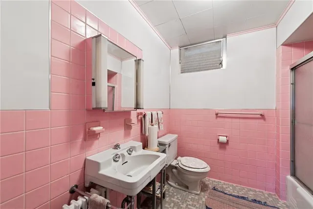 a bathroom with a sink mirror and toilet