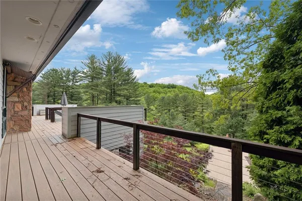 a view of balcony with wooden floor and outdoor seating