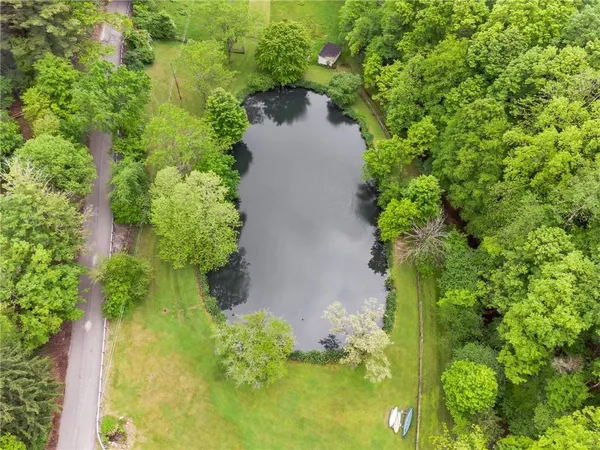 an aerial view of a house with a yard