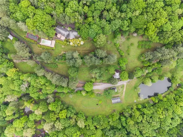 an aerial view of a house with a yard