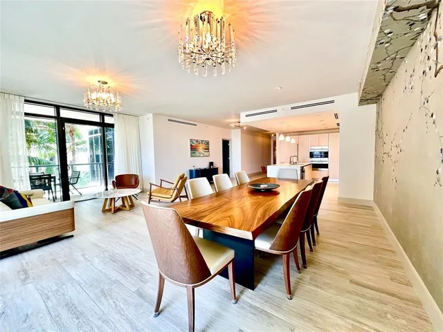 a dining room with furniture and wooden floor