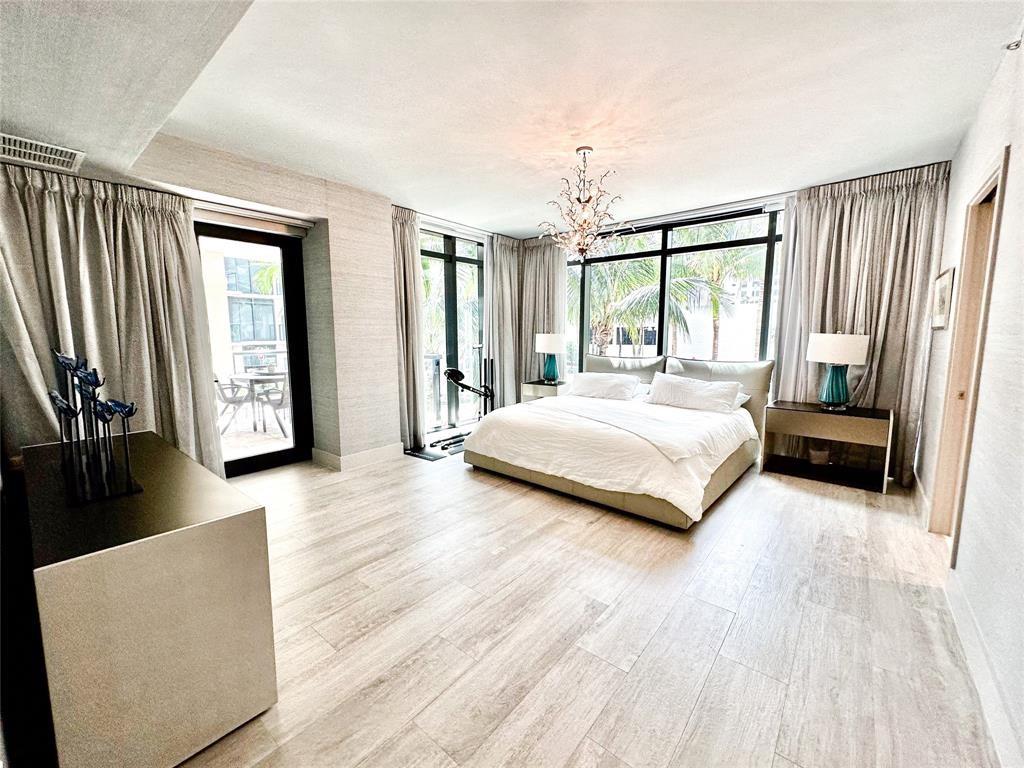 2101 South Surf Road, Unit 2C Hollywood, FL 33019 - Photo 4 of 21 a bedroom with a large bed and a large window