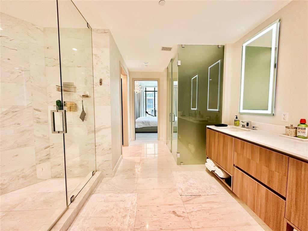 2101 South Surf Road, Unit 2C Hollywood, FL 33019 - Photo 6 of 21 a bathroom with a glass shower door and a sink