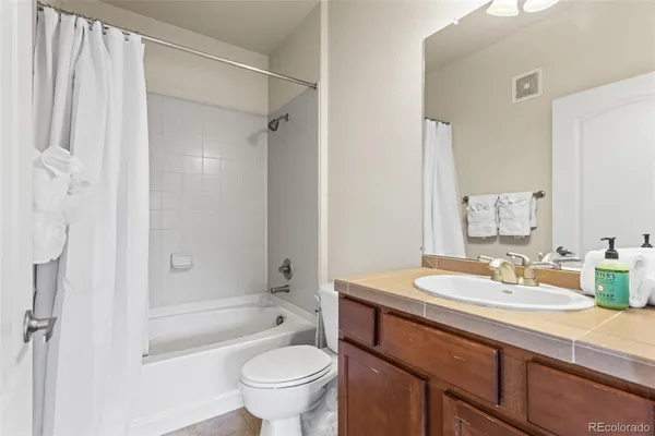 a bathroom with a sink toilet a mirror and shower