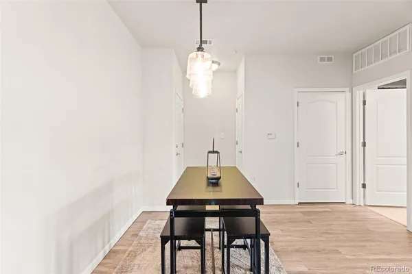 a view of a dining room with a table and chairs