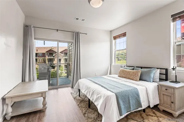 a bedroom with a large bed and a balcony view