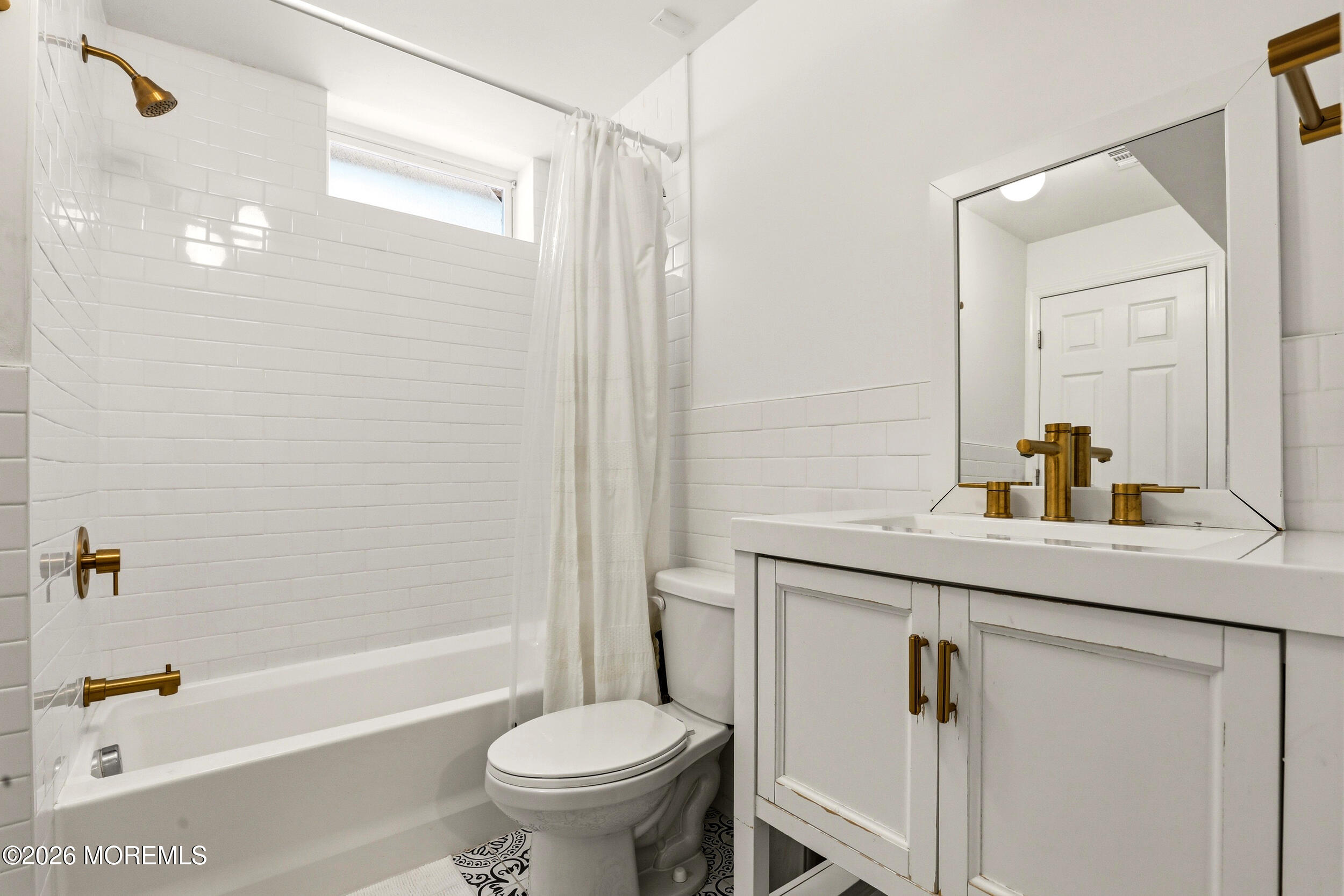2055 MacKenzie Road Toms River, NJ 08755 - Photo 36 of 56 a bathroom with a sink a toilet a mirror a bathtub and shower