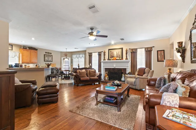a living room with furniture fireplace and a window
