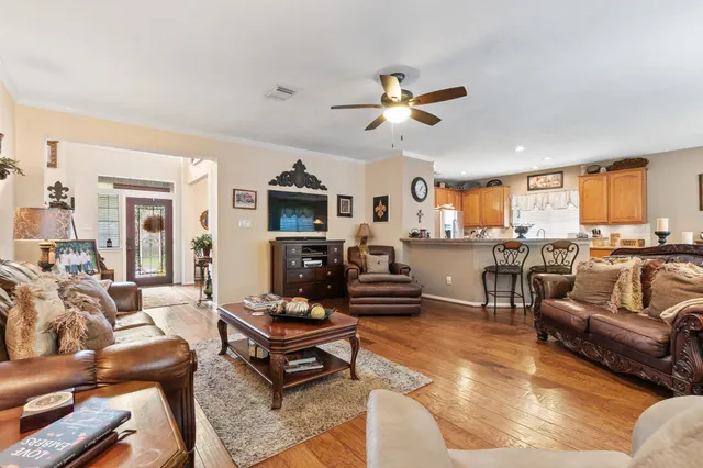a living room with furniture a fireplace and a flat screen tv