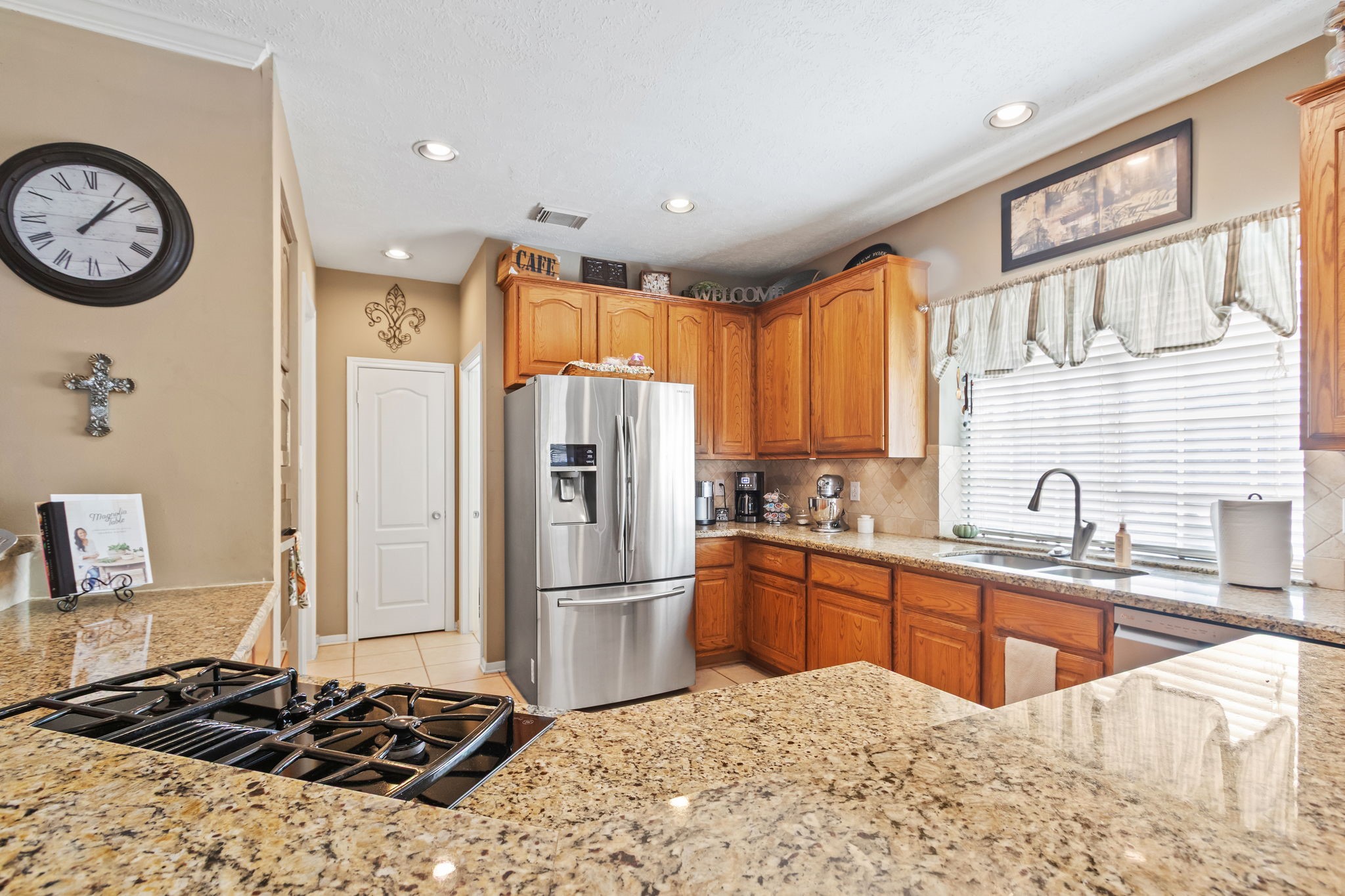 3618 Walnut Forest Lane Spring, TX 77388 - Photo 14 of 41 a kitchen with stainless steel appliances granite countertop a sink stove and refrigerator