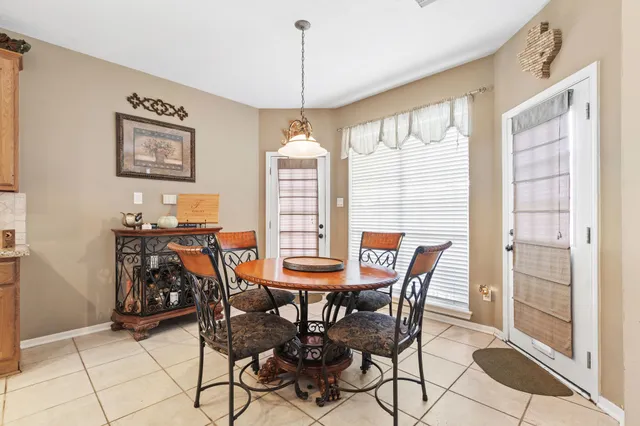 a view of a dining room with furniture and a chandelier