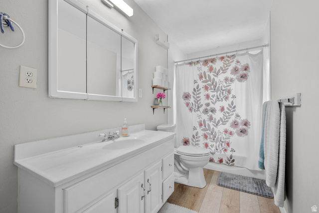 1275 North Geneva Road Provo, UT 84601 - Photo 10 of 25 Bathroom featuring a white vanity with integrated sink, chrome faucet, and a large medicine cabinet with mirrored doors