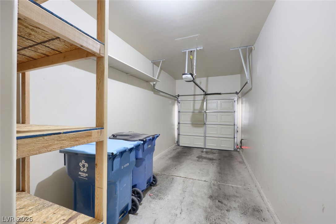 5985 High Steed Street, Unit 101 Henderson, NV 89011 - Photo 32 of 38 Functional garage with ample space for parking and storage.