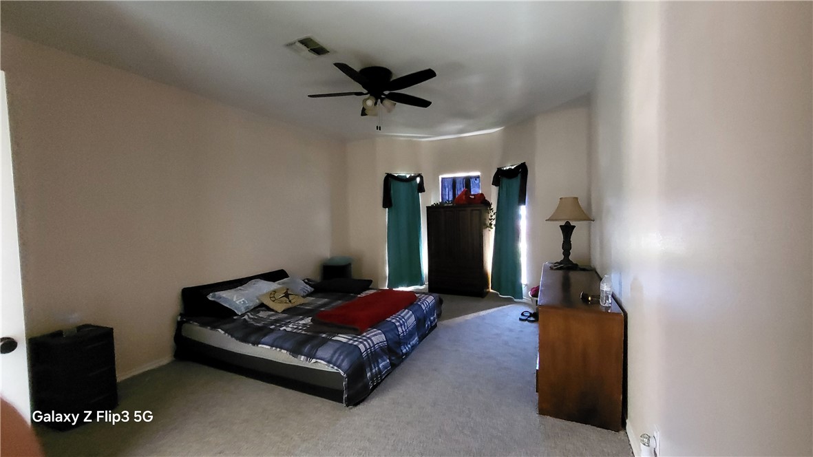 5018 Queen's Court Corpus Christi, TX 78413 - Photo 14 of 26 a living room with furniture and a ceiling fan