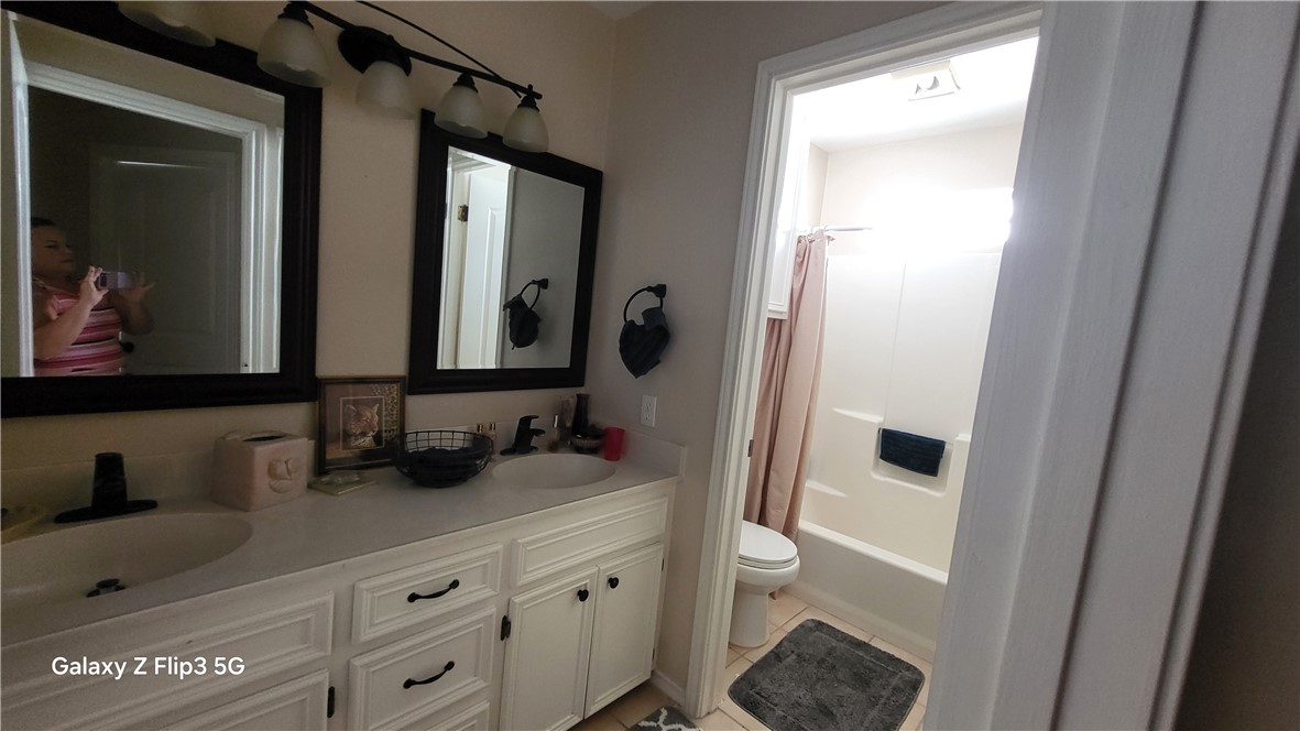 5018 Queen's Court Corpus Christi, TX 78413 - Photo 21 of 26 a bathroom with double vanity sink and two mirror