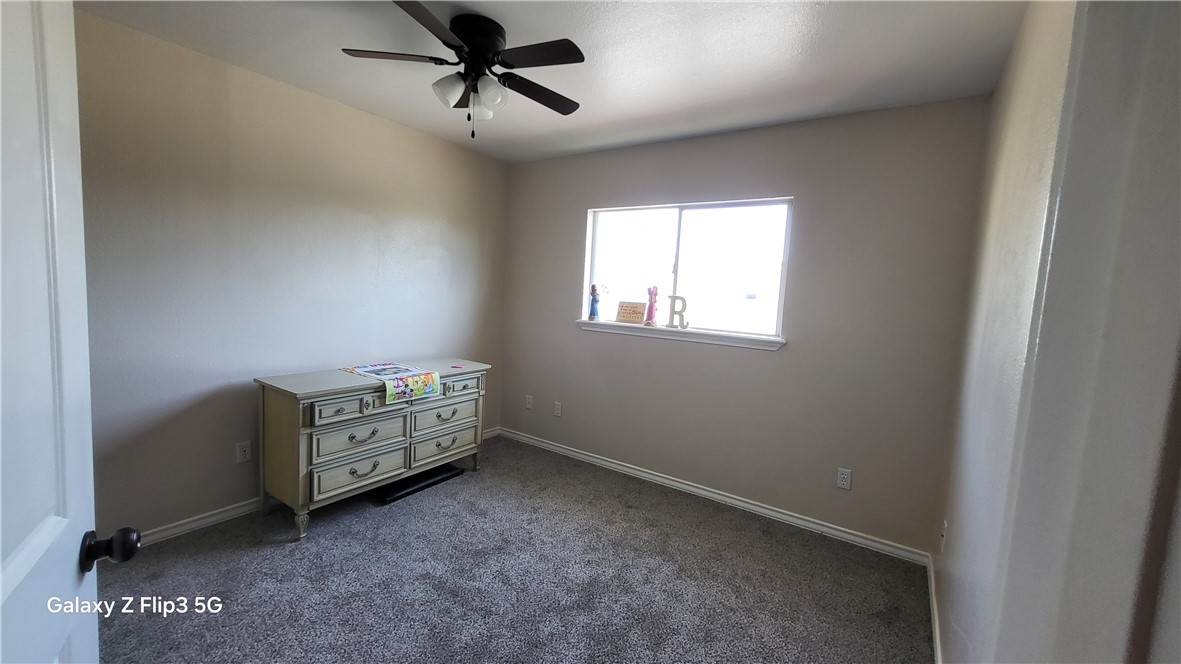 5018 Queen's Court Corpus Christi, TX 78413 - Photo 23 of 26 a room with window and a ceiling fan