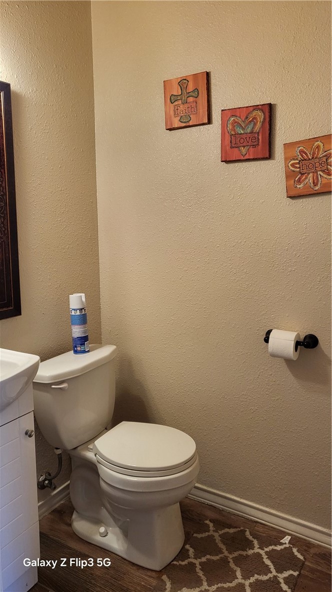 5018 Queen's Court Corpus Christi, TX 78413 - Photo 6 of 26 a white toilet sitting next to a white sink and vanity