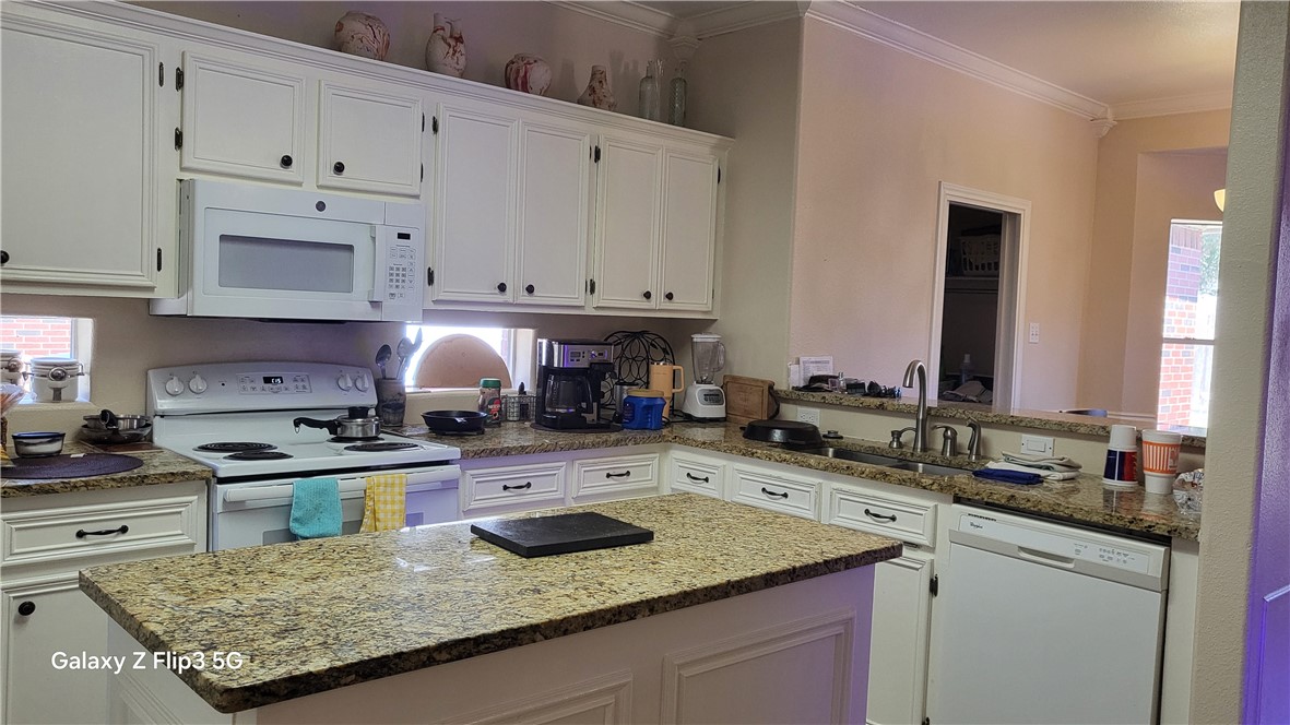 5018 Queen's Court Corpus Christi, TX 78413 - Photo 7 of 26 a kitchen with stainless steel appliances granite countertop a sink stove and cabinets