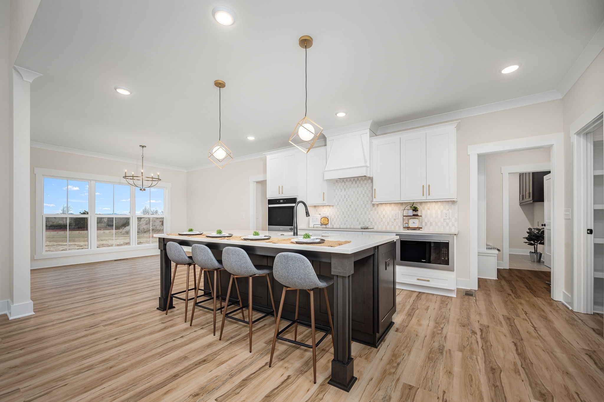7302 West Gum Road Murfreesboro, TN 37127 - Photo 17 of 53 a kitchen with stainless steel appliances a kitchen island hardwood floor sink stove dining table and chairs