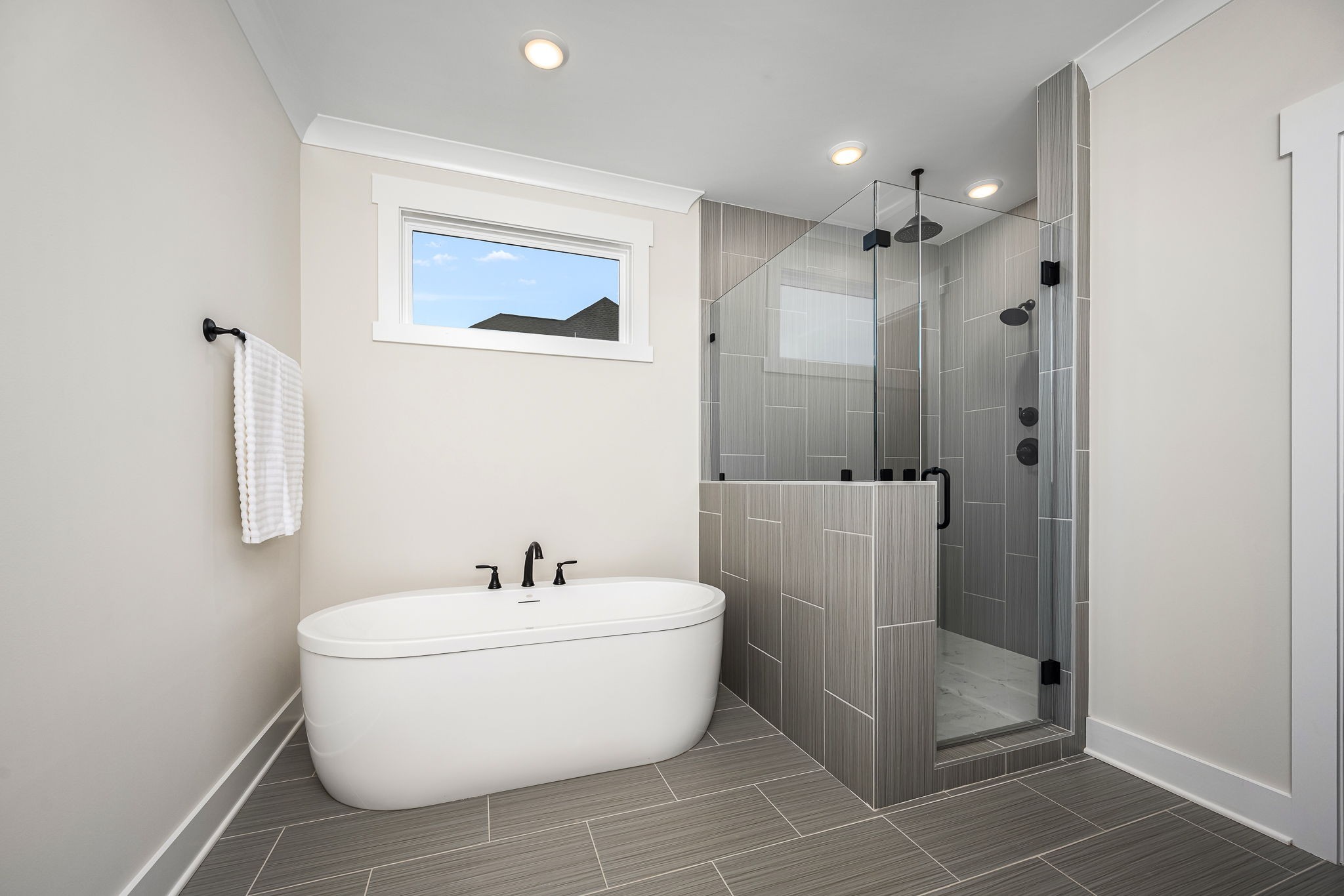 7302 West Gum Road Murfreesboro, TN 37127 - Photo 31 of 53 a bathroom with a white tub shower sink and mirror