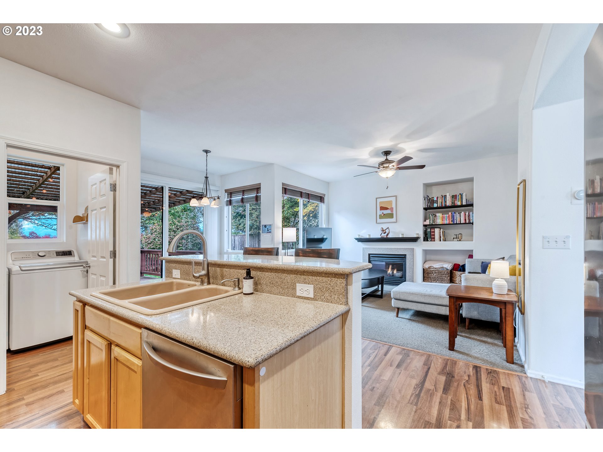 5588 Wales Drive Eugene, OR 97402 - Photo 19 of 41 a living room with stainless steel appliances kitchen island granite countertop furniture and a wooden floor